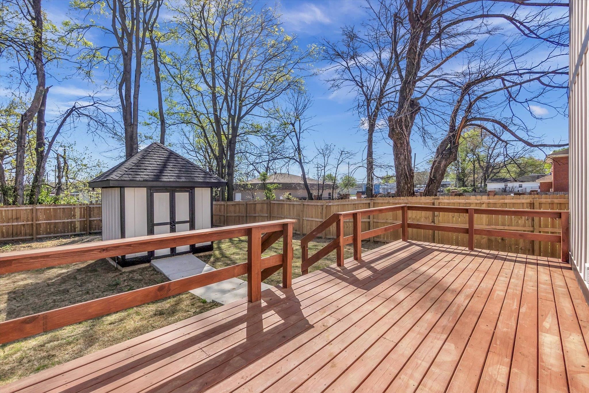 574 Lipford Street Memphis, TN 38112 - Photo 25 of 26 a view of a roof deck with wooden floor and fence