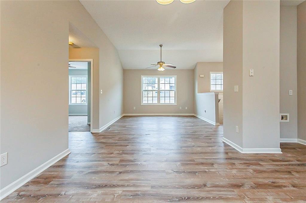 427 Southridge Road Winder, GA 30680 - Photo 11 of 31 an empty room with wooden floor and windows