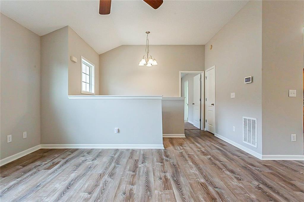 427 Southridge Road Winder, GA 30680 - Photo 12 of 31 a view of an empty room with wooden floor and a window