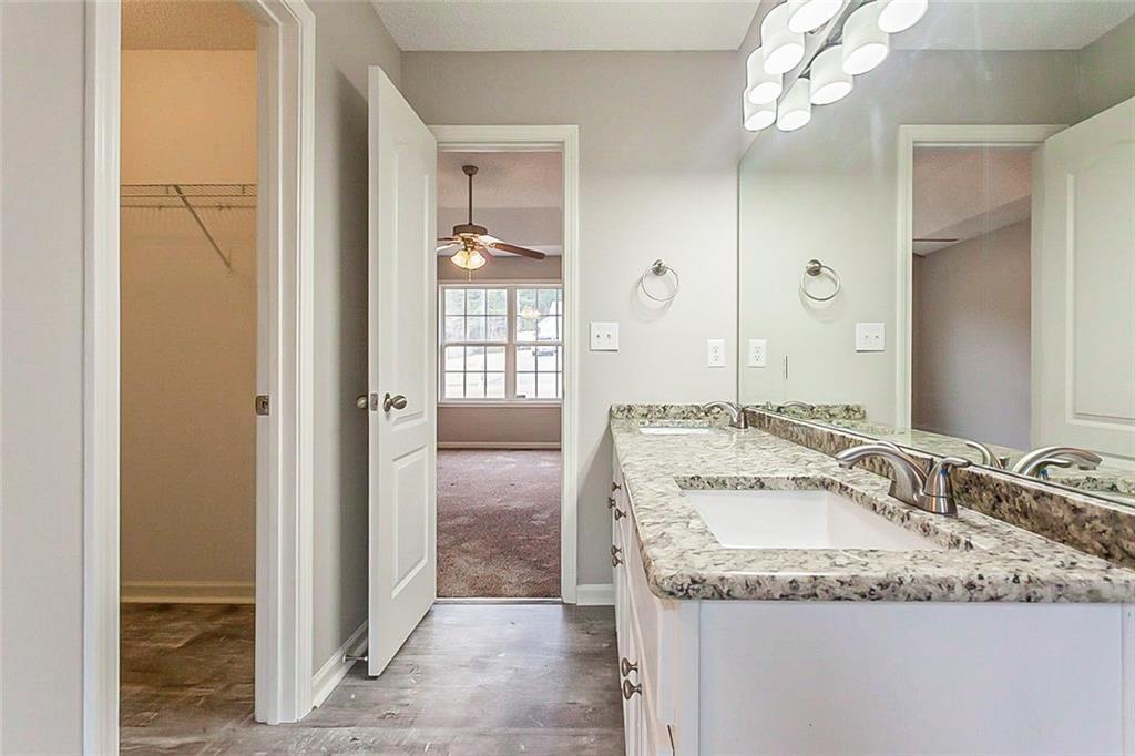 427 Southridge Road Winder, GA 30680 - Photo 17 of 31 a bathroom with a granite countertop sink and a mirror