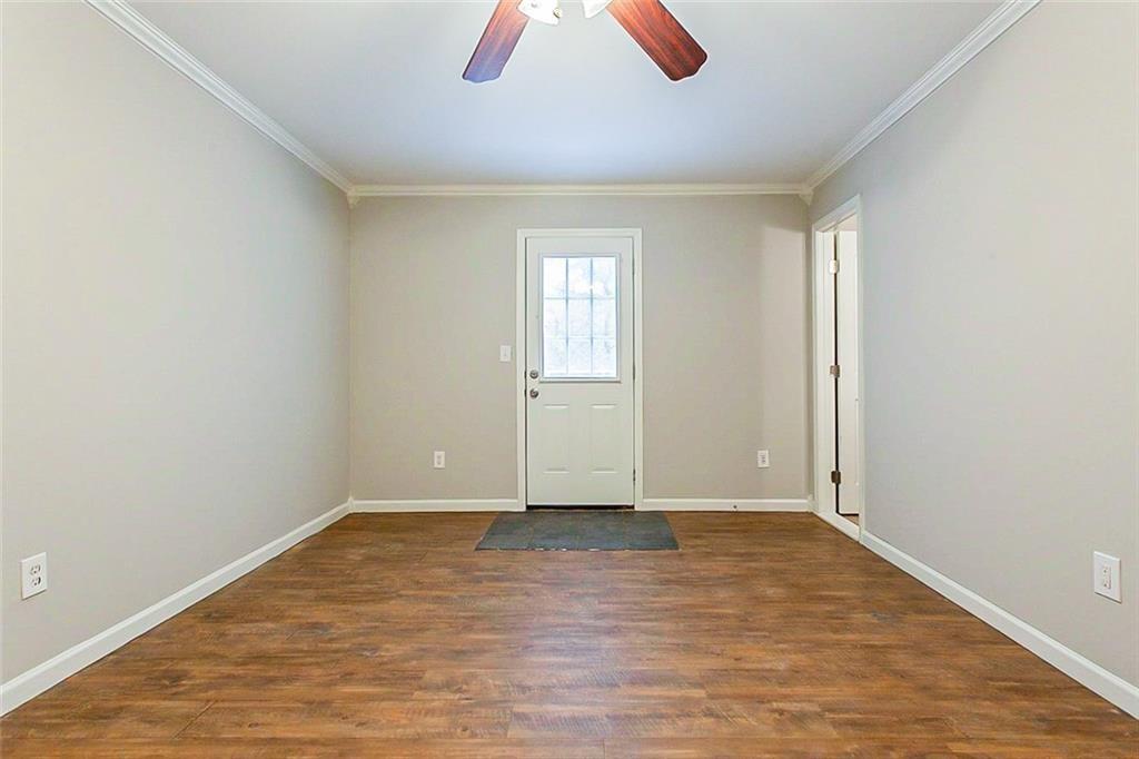 427 Southridge Road Winder, GA 30680 - Photo 18 of 31 an empty room with wooden floor and windows