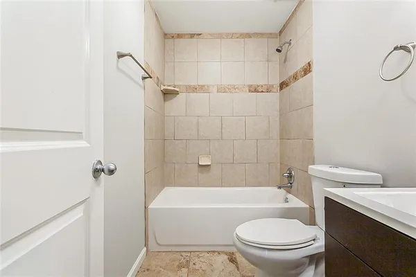 a bathroom with a toilet sink and shower