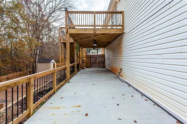 a view of a backyard with wooden fence