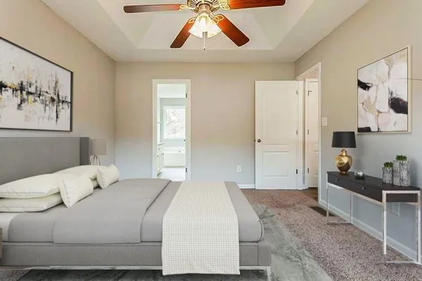 a bedroom with a bed and painting on the wall