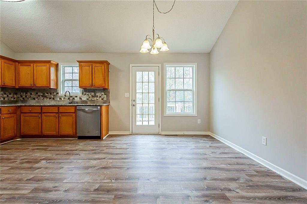 427 Southridge Road Winder, GA 30680 - Photo 9 of 31 a view of a kitchen with granite countertop cabinets and wooden floor