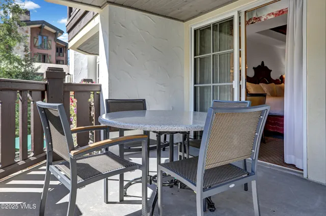 a view of a dining room with furniture and a potted plant