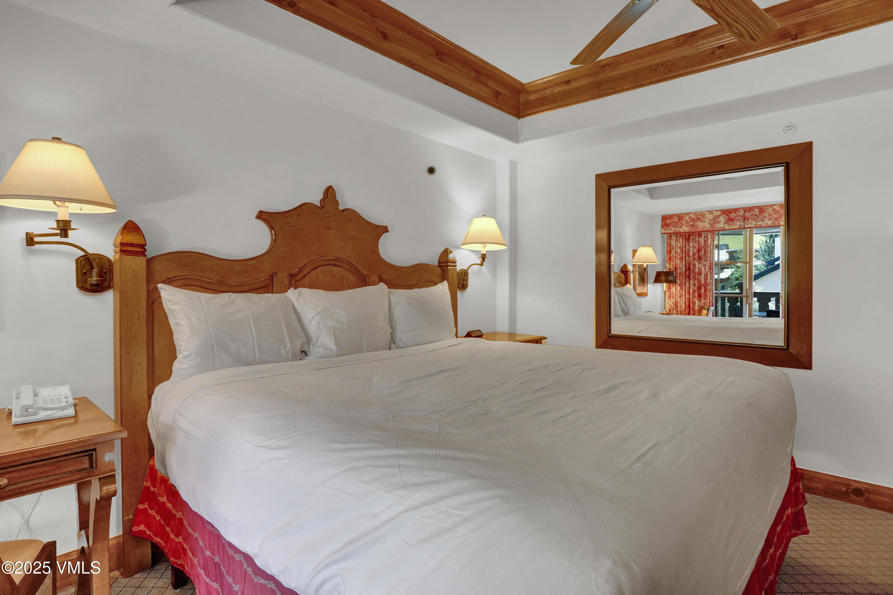 242 East Meadow Drive, Unit 3035 Vail, CO 81657 - Photo 13 of 28 a bed room with a bed and a lamp