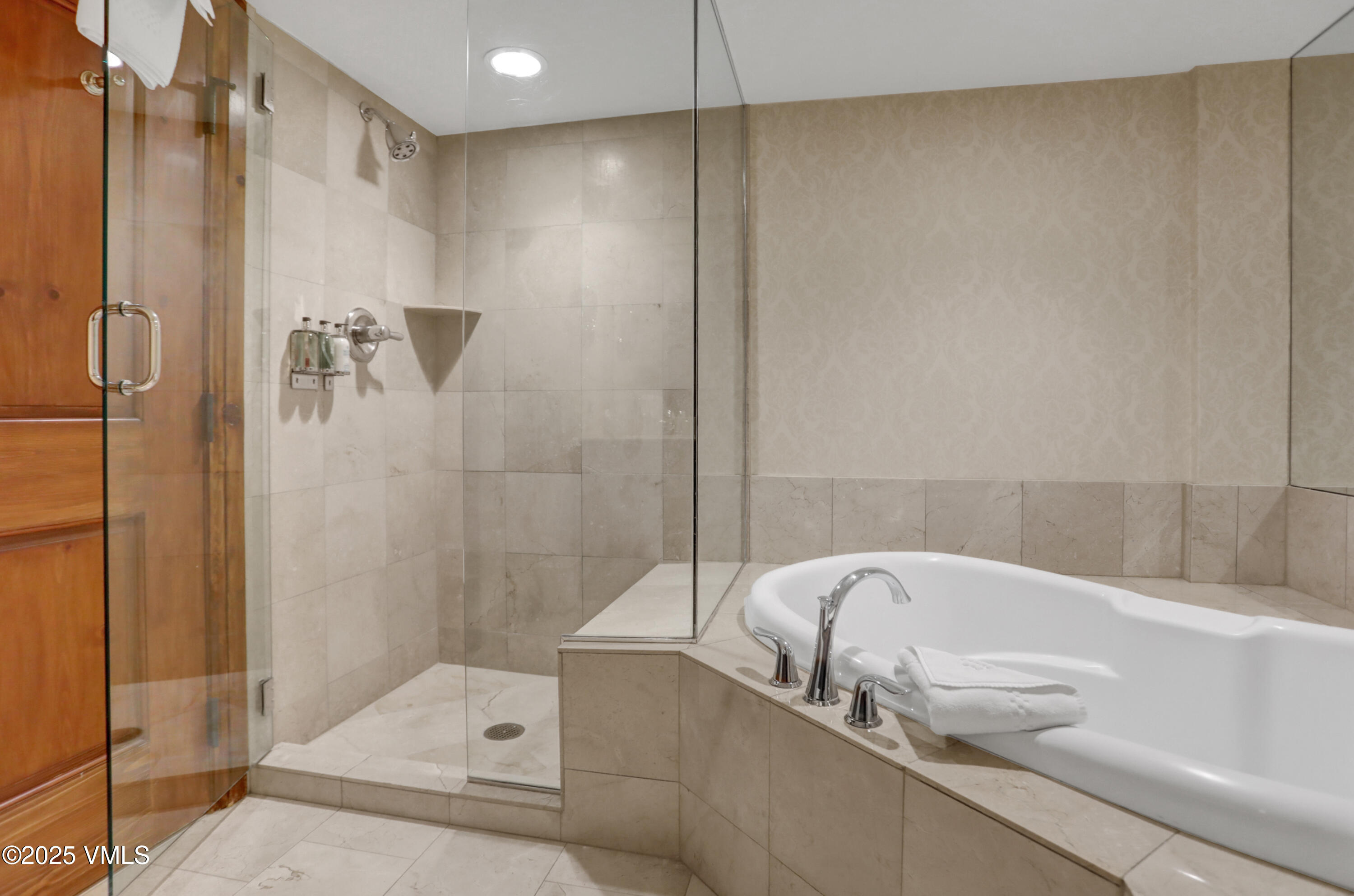 242 East Meadow Drive, Unit 3035 Vail, CO 81657 - Photo 16 of 28 a bathroom with a tub and shower