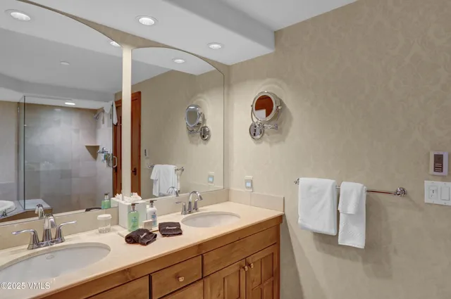 a bathroom with a double vanity sink mirror and double