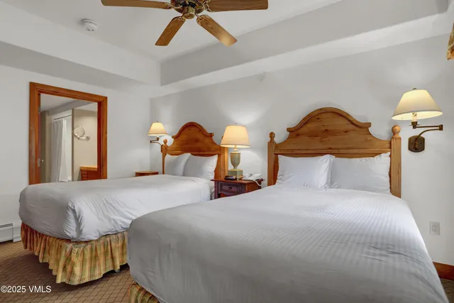 a bedroom with a bed and flowerpot