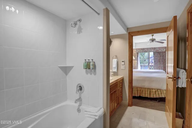 a bathroom with a tub and shower