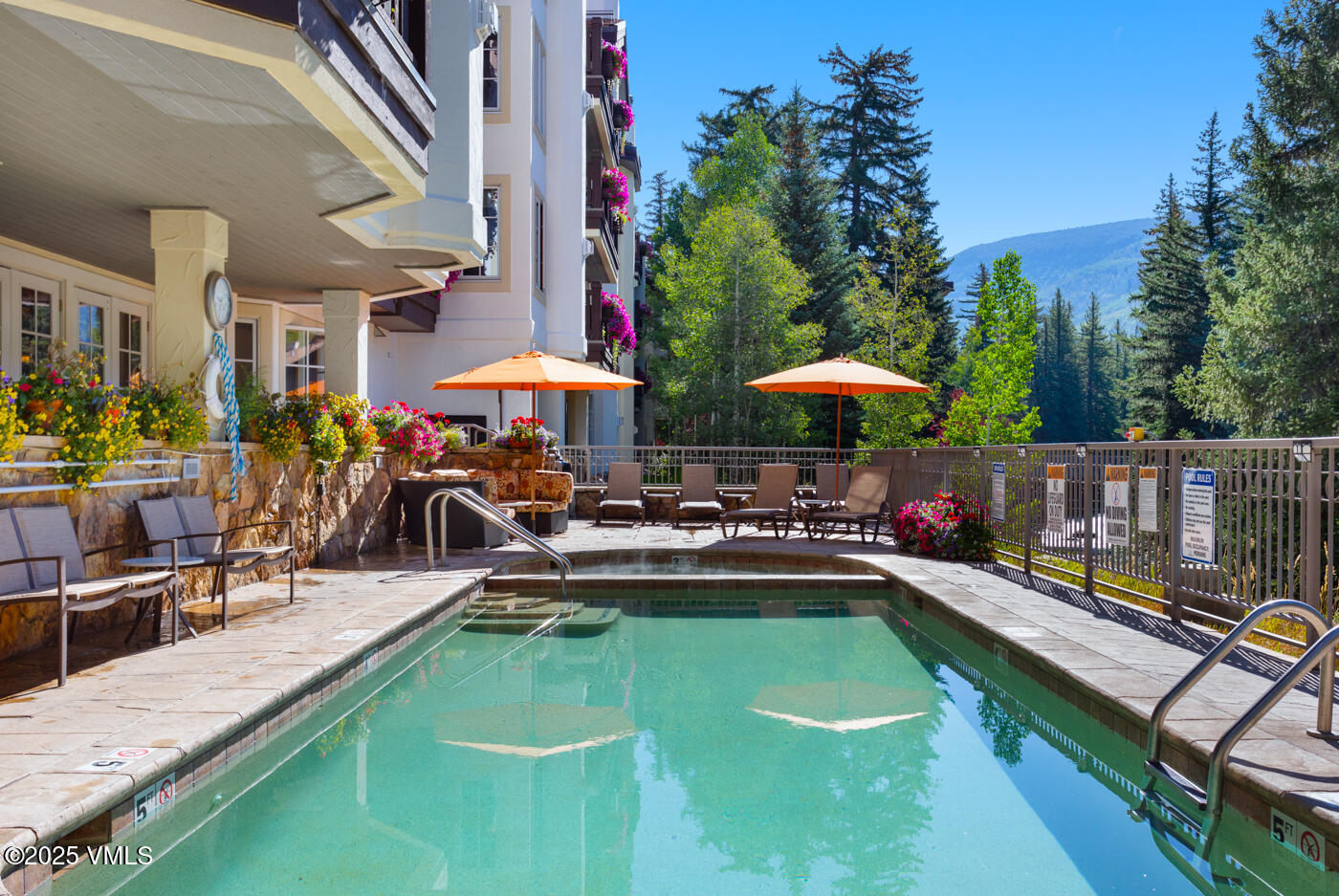 242 East Meadow Drive, Unit 3035 Vail, CO 81657 - Photo 23 of 28 a view of a swimming pool with chairs in patio