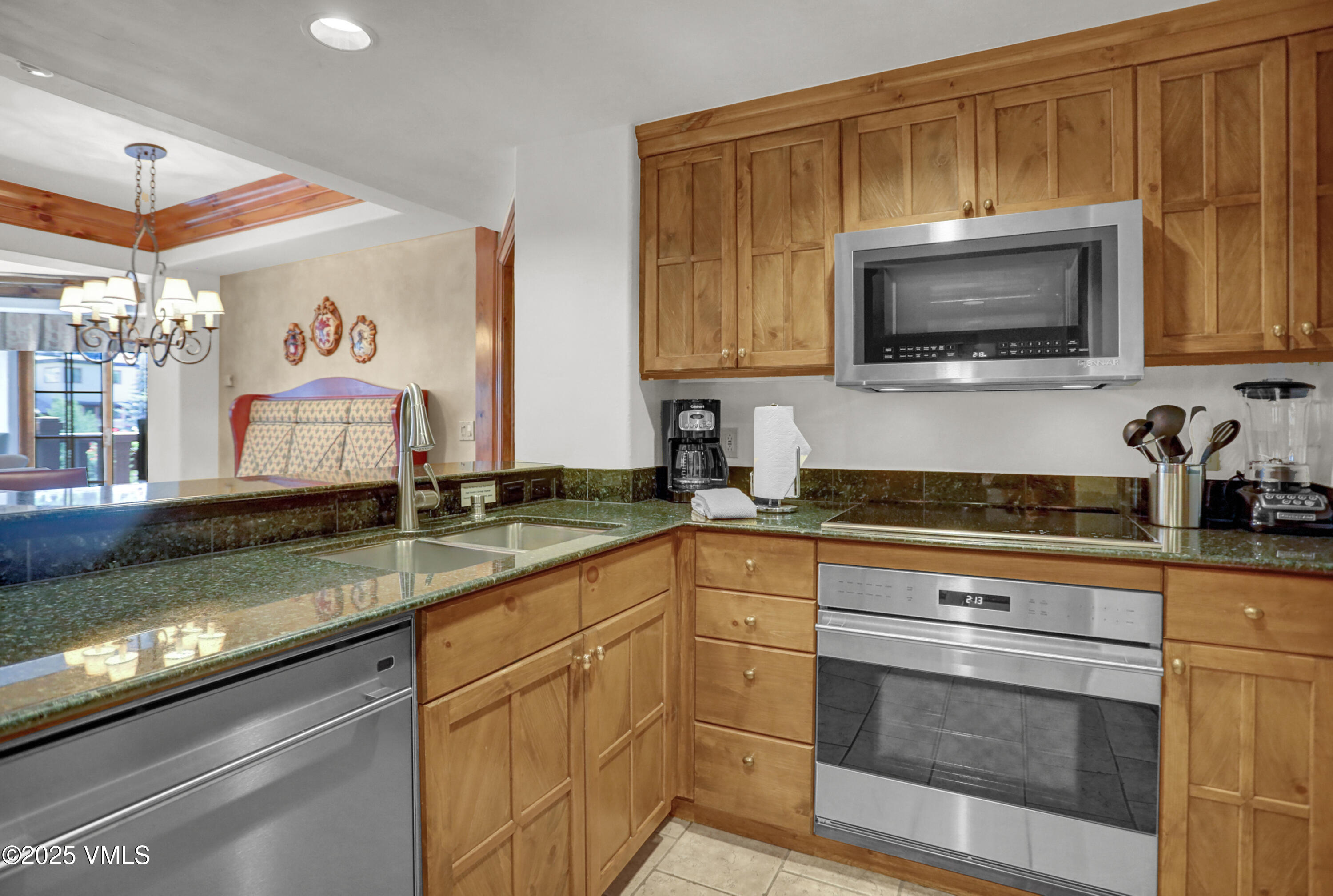 242 East Meadow Drive, Unit 3035 Vail, CO 81657 - Photo 4 of 28 a kitchen with a stove and a sink