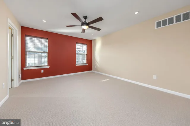 a view of a livingroom with a ceiling fan and window