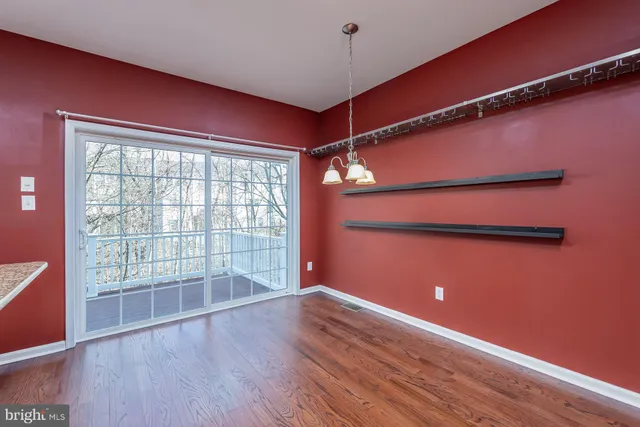 a view of a room with wooden floor and windows