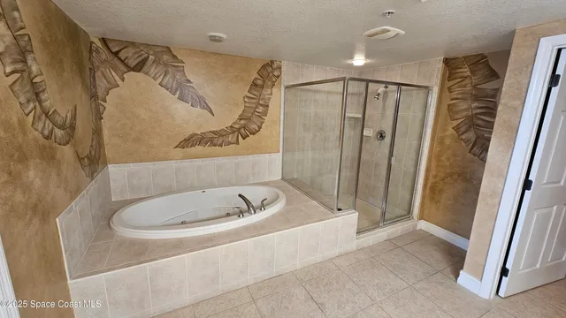 a bathroom with a tub a sink and glass door shower