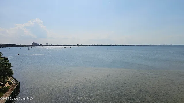 an aerial view of a house with outdoor space and lake view