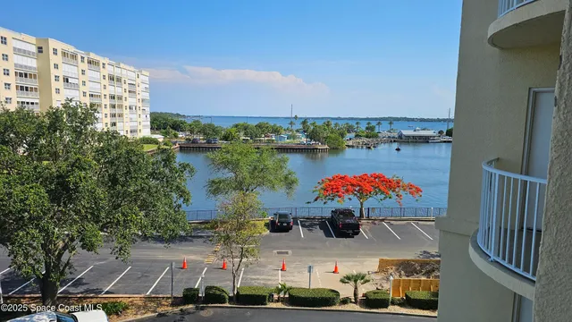 a view of a big room with wooden floor and city view