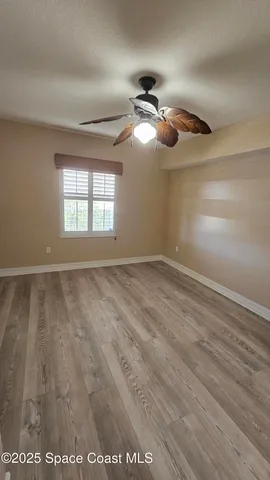 a view of room with window and ceiling fan