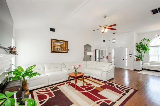 a living room with furniture and a chandelier