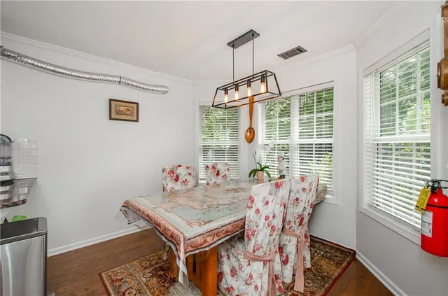 a view of a dining room with furniture wooden floor and a chandelier