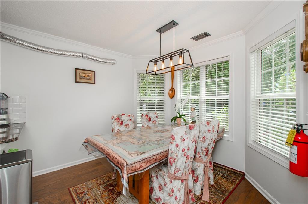 722 Moonlite Trace Winder, GA 30680 - Photo 15 of 41 a view of a dining room with furniture wooden floor and a chandelier