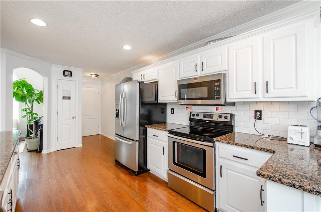 722 Moonlite Trace Winder, GA 30680 - Photo 16 of 41 a kitchen with stainless steel appliances granite countertop a stove a refrigerator and a microwave