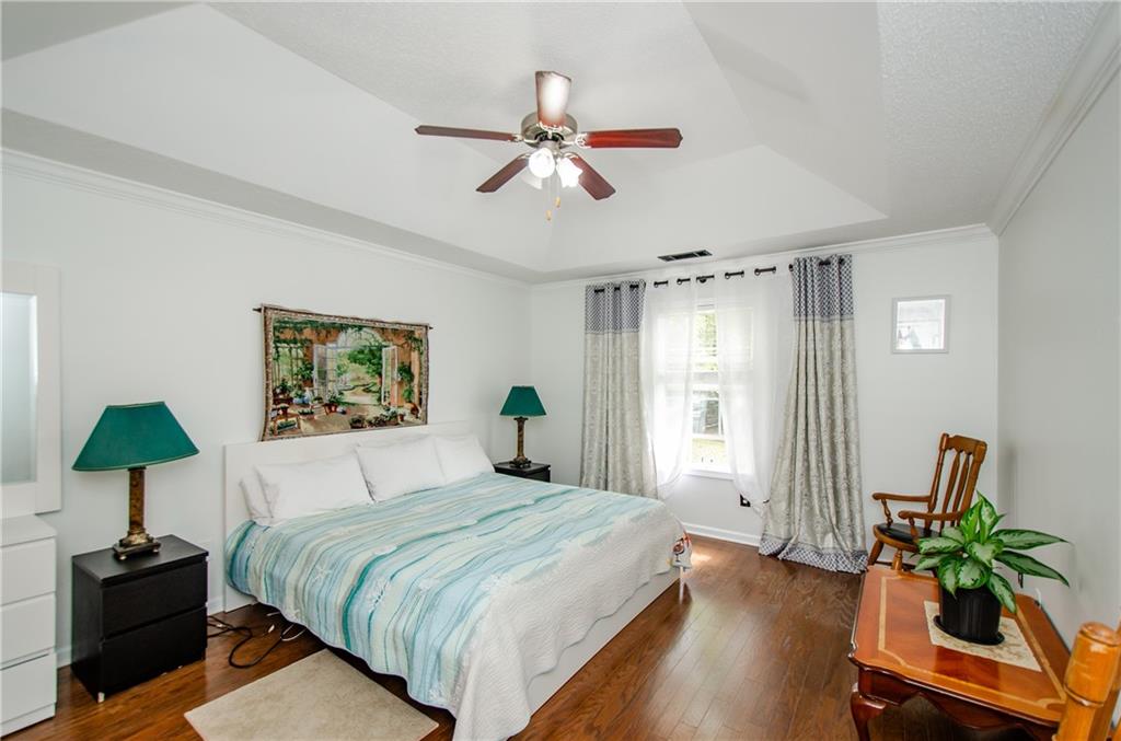 722 Moonlite Trace Winder, GA 30680 - Photo 17 of 41 a bedroom with a bed and a chandelier