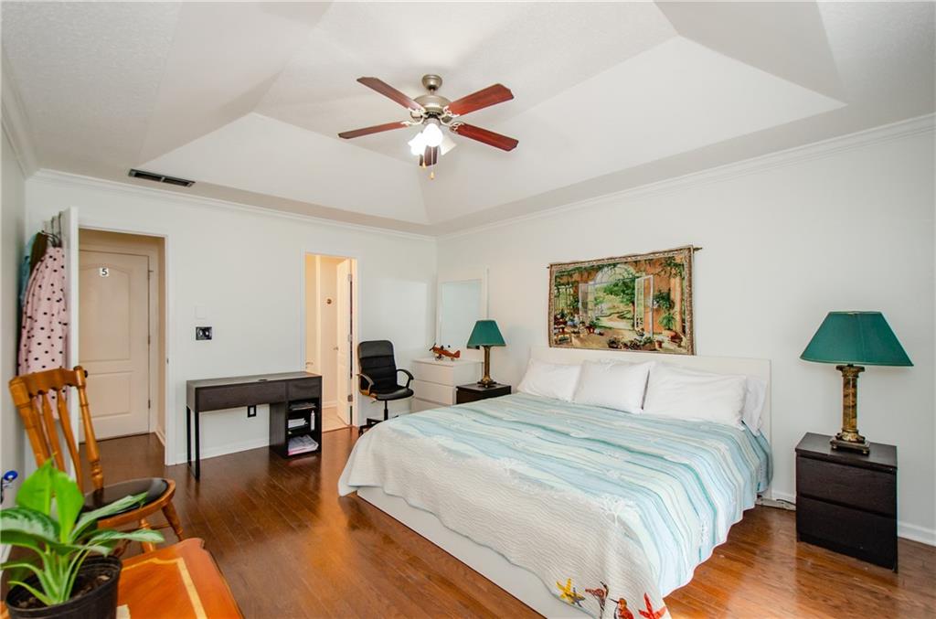 722 Moonlite Trace Winder, GA 30680 - Photo 18 of 41 a bedroom with a bed and a chandelier