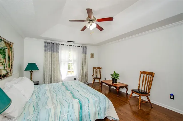 a bedroom with a bed and a chair