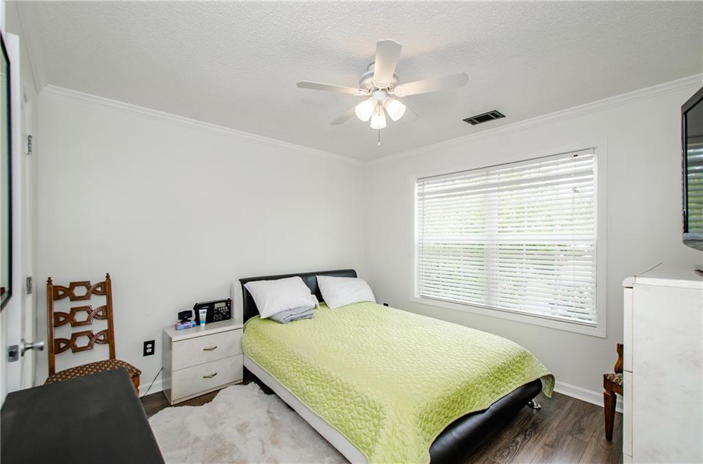 722 Moonlite Trace Winder, GA 30680 - Photo 24 of 41 a bedroom with a bed and a chandelier