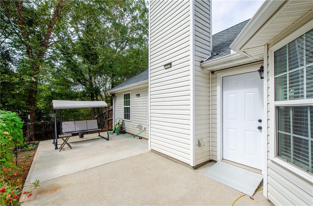 722 Moonlite Trace Winder, GA 30680 - Photo 30 of 41 a view of patio with a table and chairs and a large tree