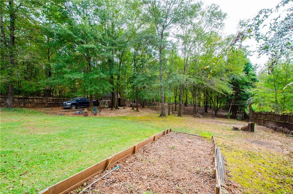 722 Moonlite Trace Winder, GA 30680 - Photo 32 of 41 a view of a backyard with a garden