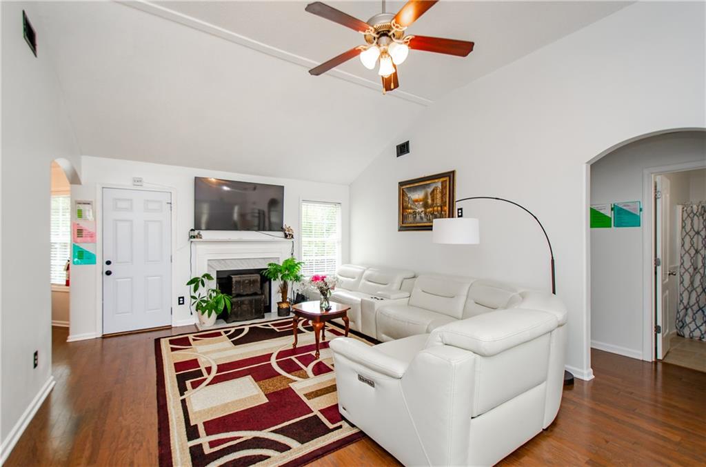 722 Moonlite Trace Winder, GA 30680 - Photo 8 of 41 a living room with furniture a flat screen tv and a fireplace