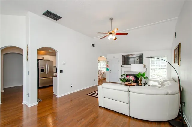 a living room with furniture and wooden floor