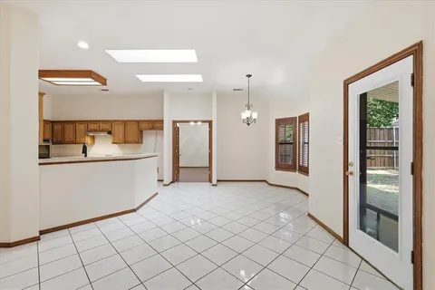 a kitchen that has a sink a stove and chairs