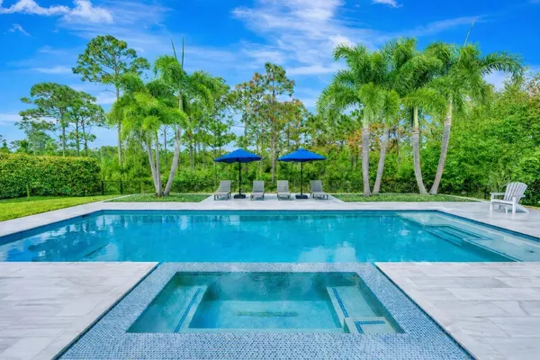 a view of a swimming pool with a yard