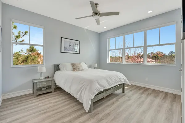 a bedroom with a bed and a painting on the wall