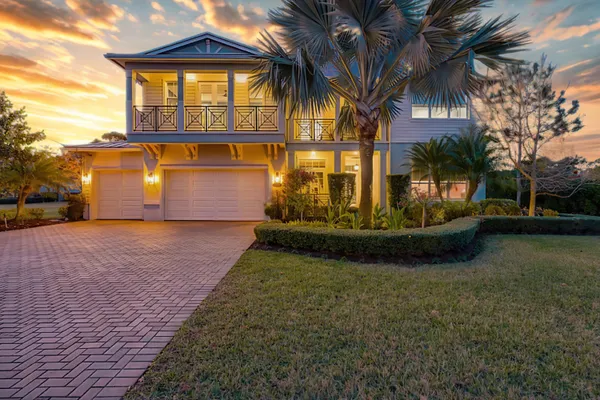 a view of a house with a yard and pathway
