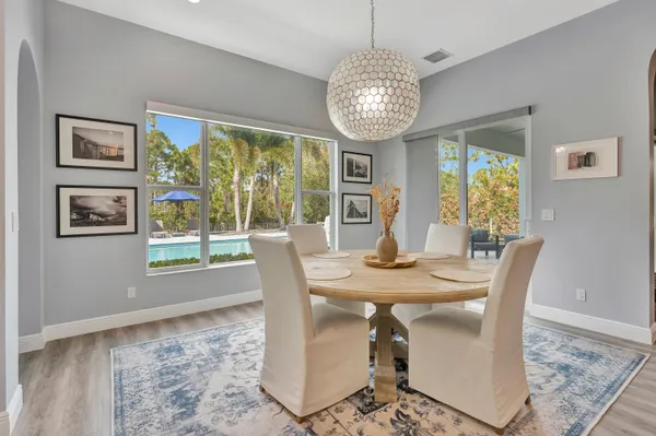 a view of a dining room with furniture window and wooden floor