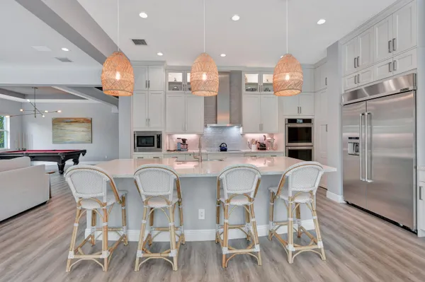 a large kitchen with a table and chairs in it