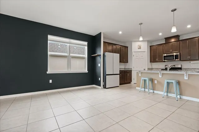 a kitchen with stainless steel appliances a refrigerator sink and microwave