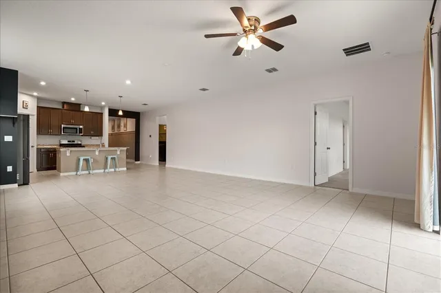 a view of a kitchen with furniture and a ceiling fan