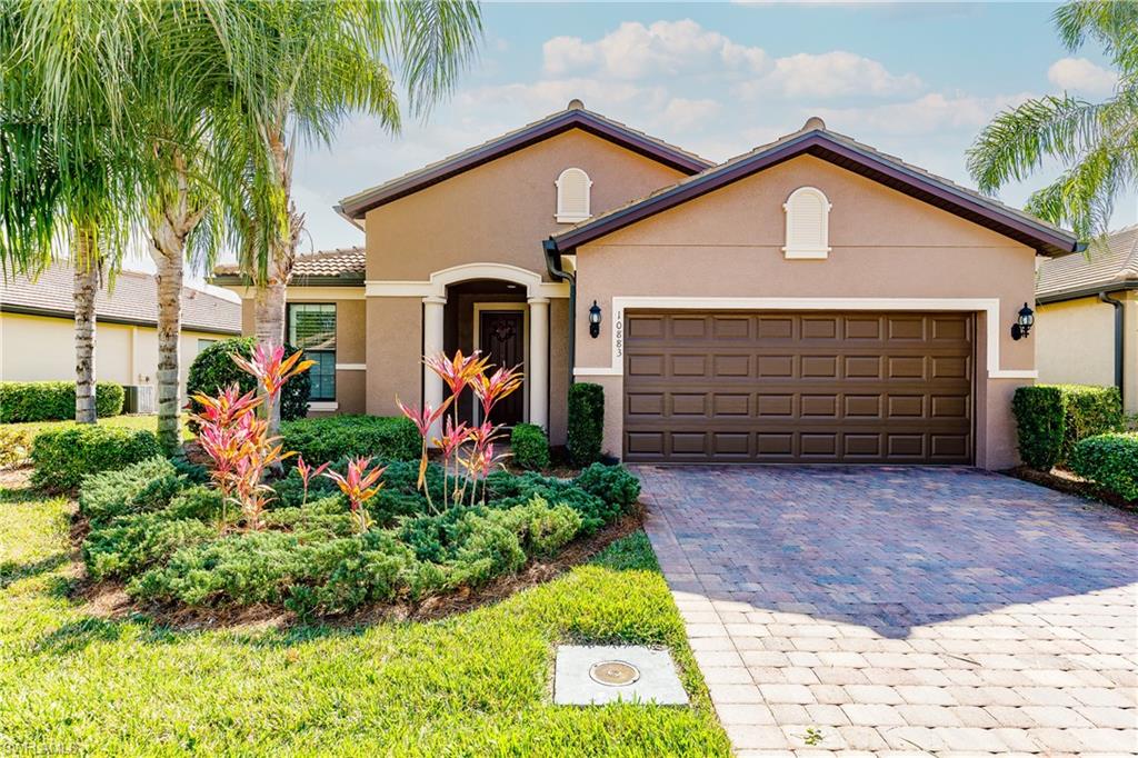 10883 Dennington Road Fort Myers, FL 33913 - Photo 1 of 32 a front view of a house with a yard and garage