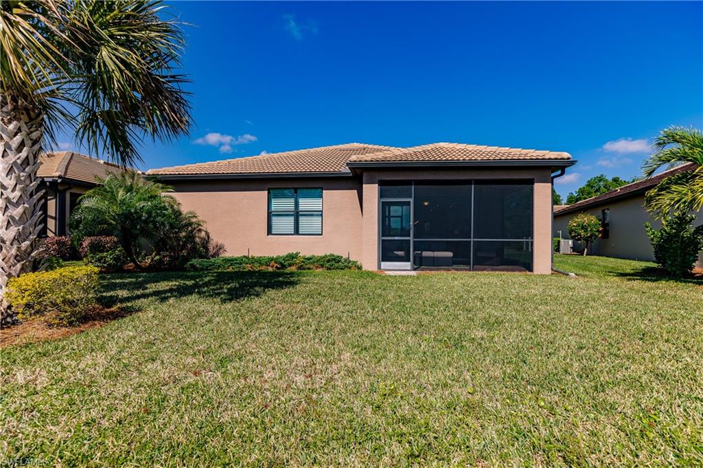 10883 Dennington Road Fort Myers, FL 33913 - Photo 30 of 32 a view of house with backyard and glass windows
