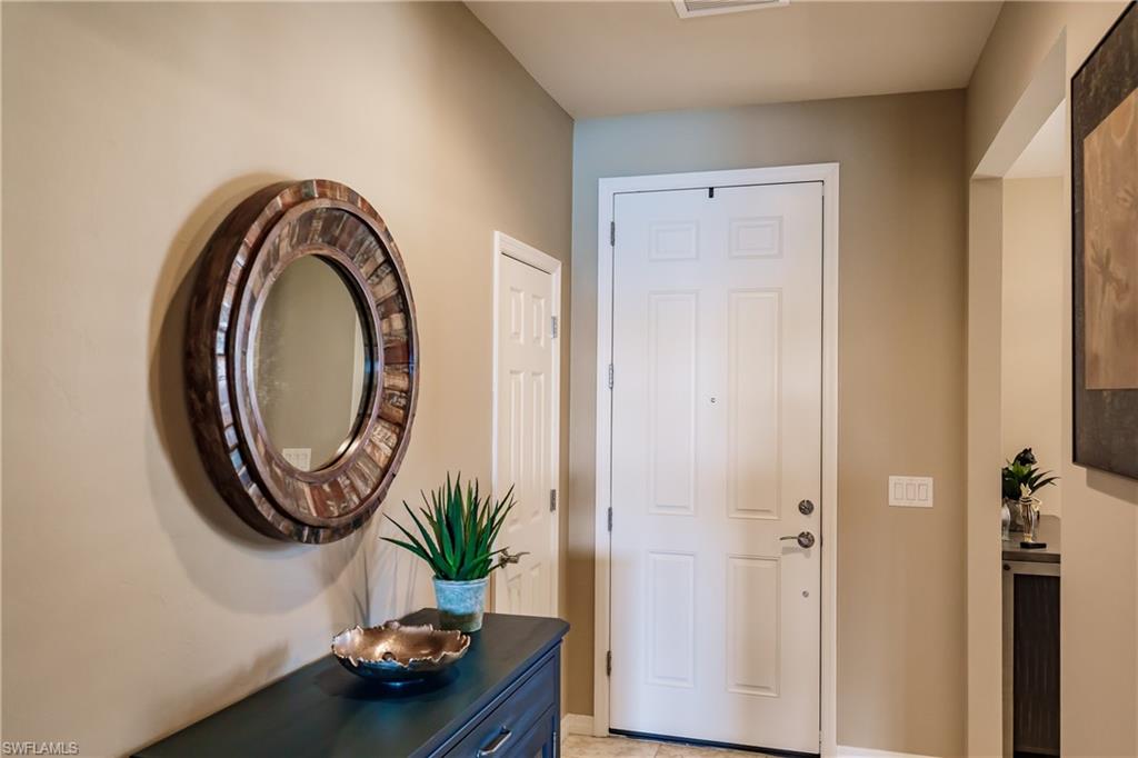 10883 Dennington Road Fort Myers, FL 33913 - Photo 3 of 32 a bathroom with a sink a mirror and a window