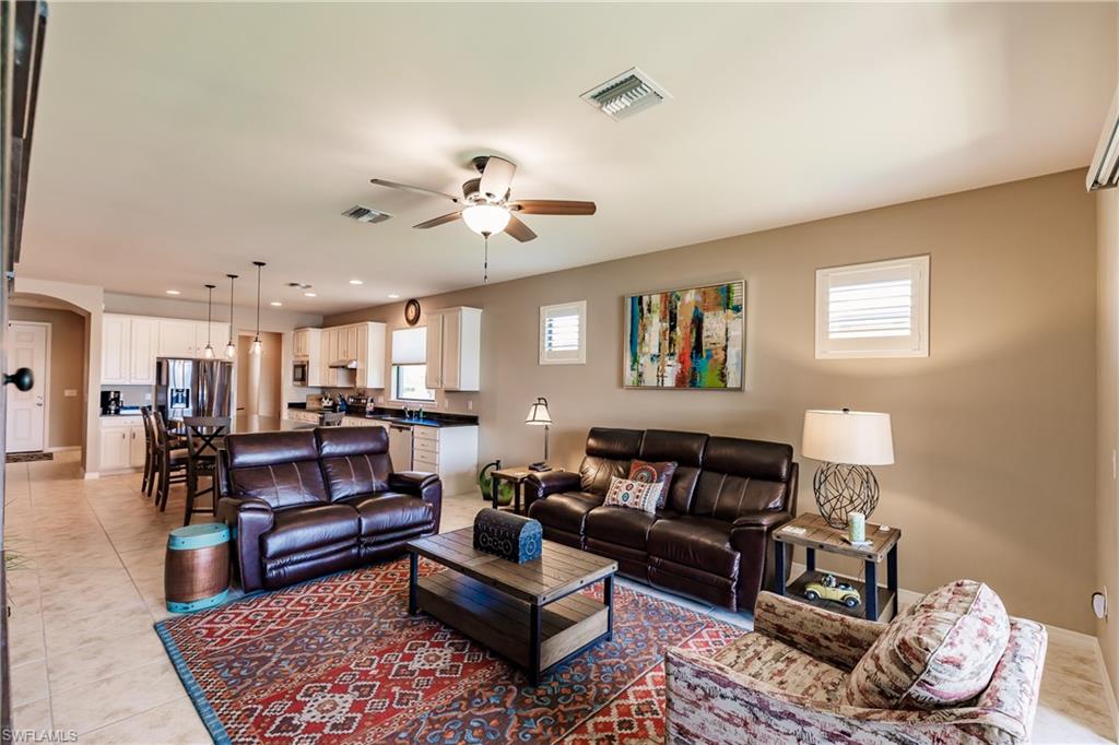 10883 Dennington Road Fort Myers, FL 33913 - Photo 4 of 32 a living room with furniture and a rug