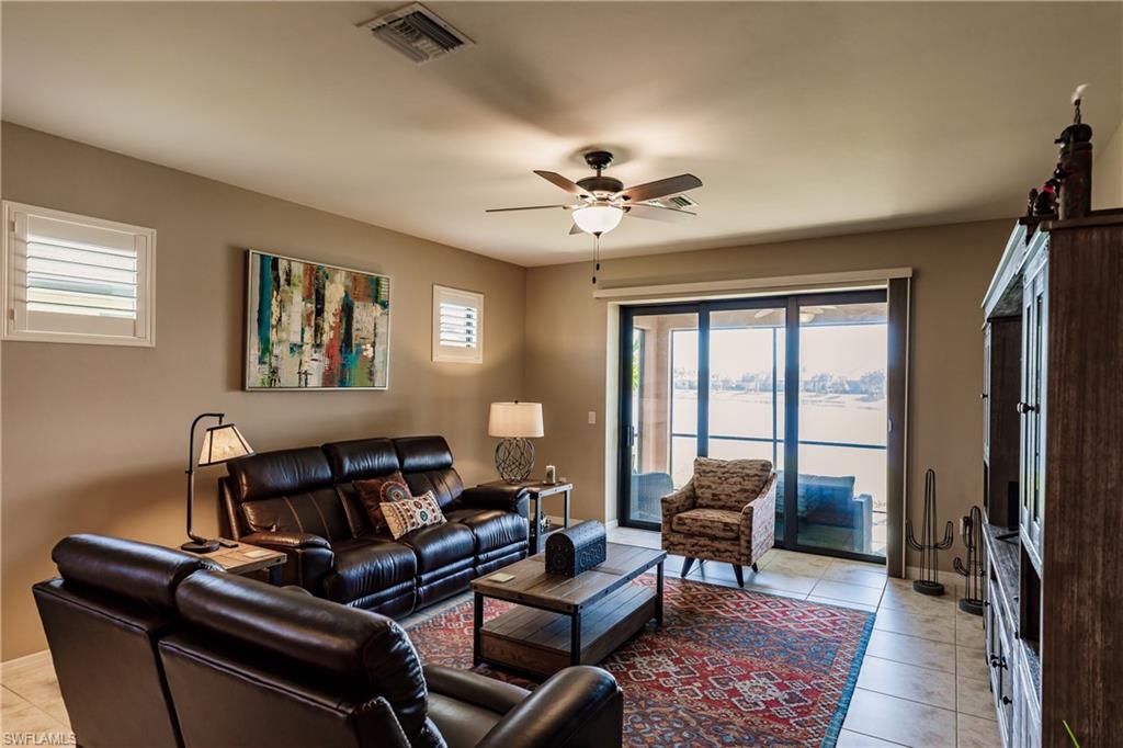 10883 Dennington Road Fort Myers, FL 33913 - Photo 6 of 32 a living room with furniture a ceiling fan and a window