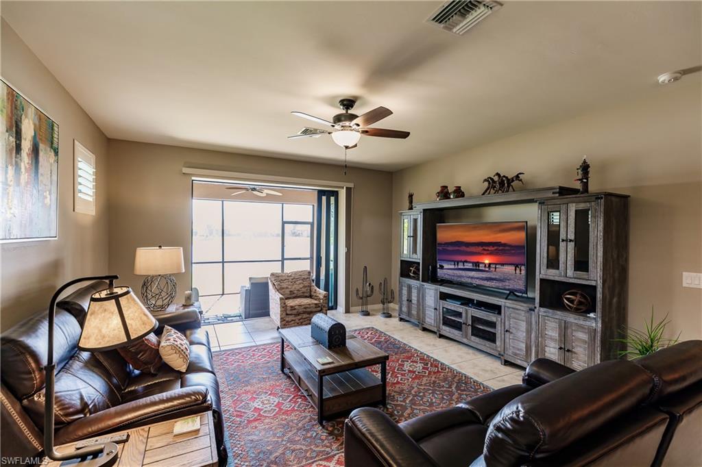 10883 Dennington Road Fort Myers, FL 33913 - Photo 8 of 32 a living room with furniture and a flat screen tv
