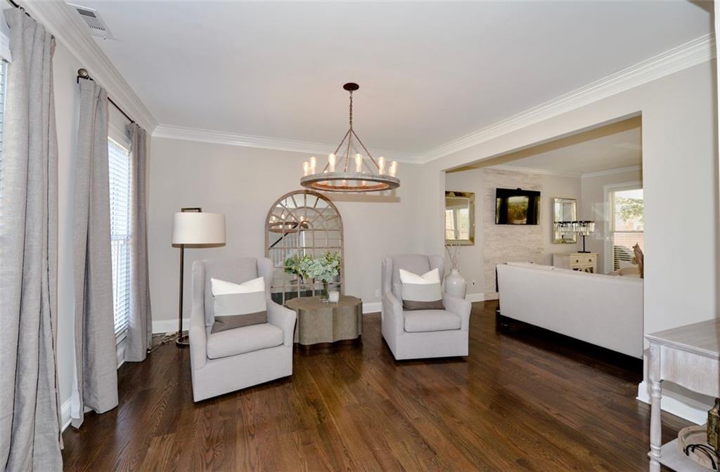 310 Windsor Gate Cove Northeast Atlanta, GA 30342 - Photo 15 of 58 a living room with furniture and a chandelier